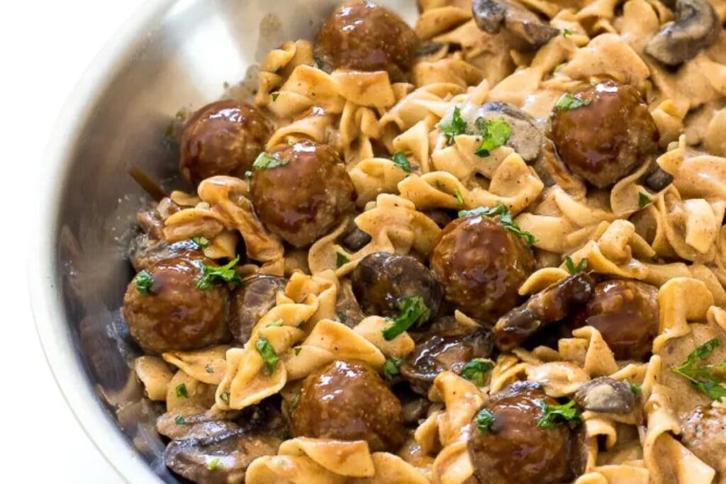 Meatball stroganoff with egg noodles and mushrooms in a creamy sauce.