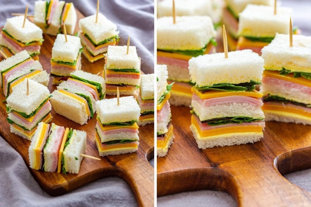 Mini ham and cheese sandwiches with lettuce on a wooden board.
