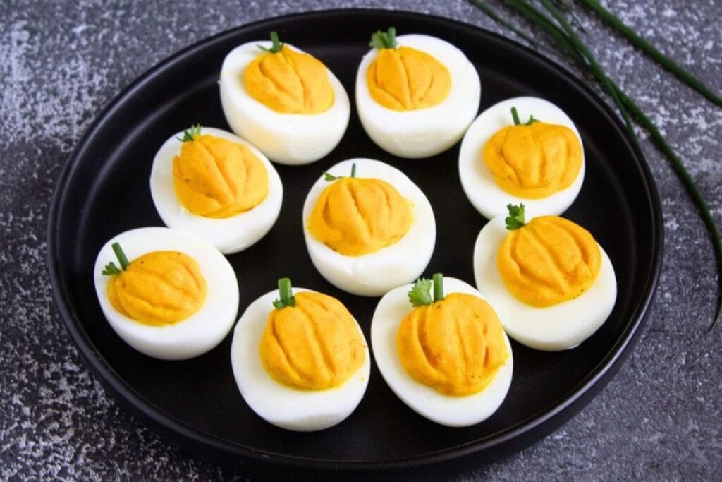 A close up shot of pumpkin deviled eggs.