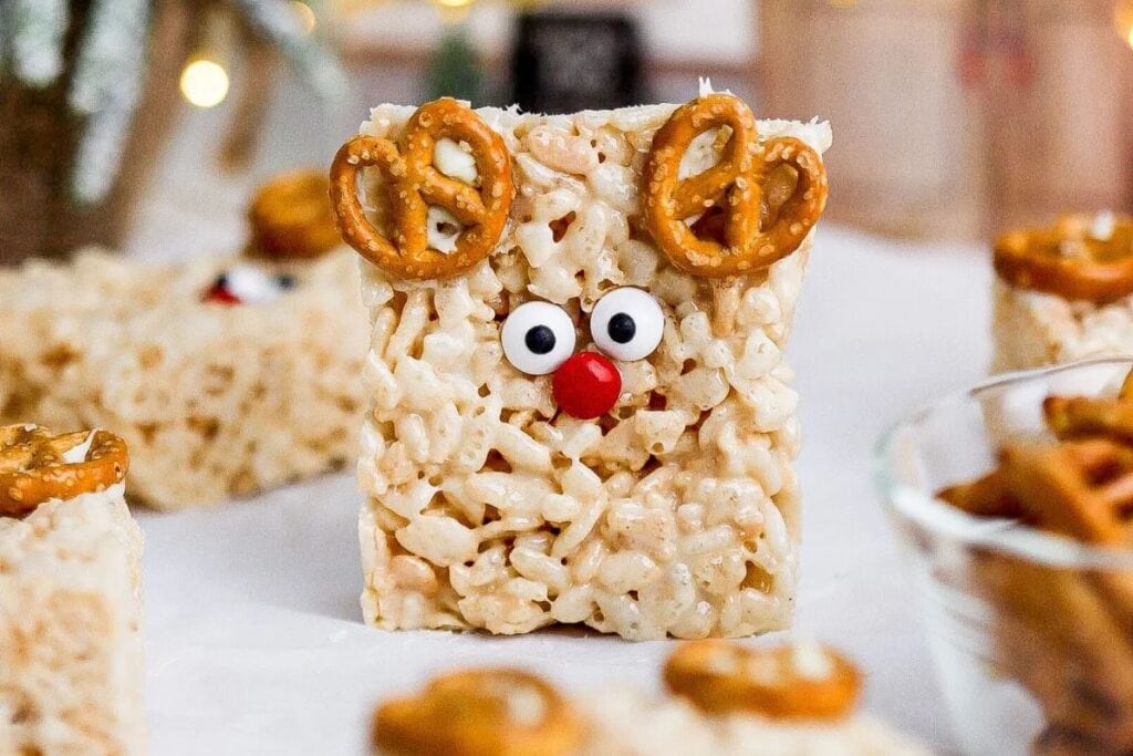 Close-up of a reindeer Rice Krispie treat with pretzel antlers.