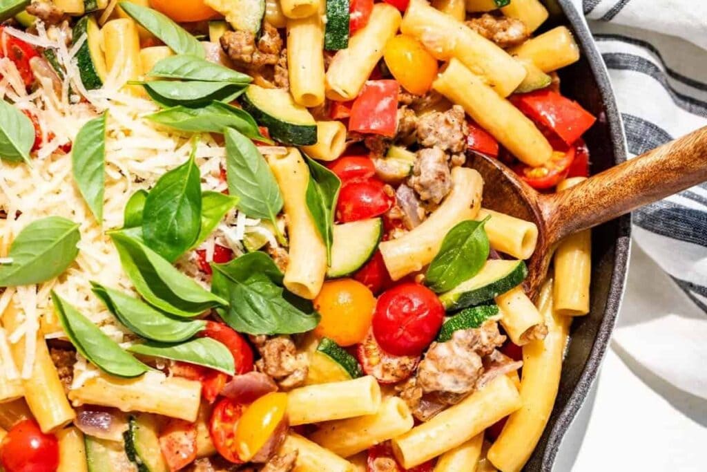 A close up shot of sausage and peppers.