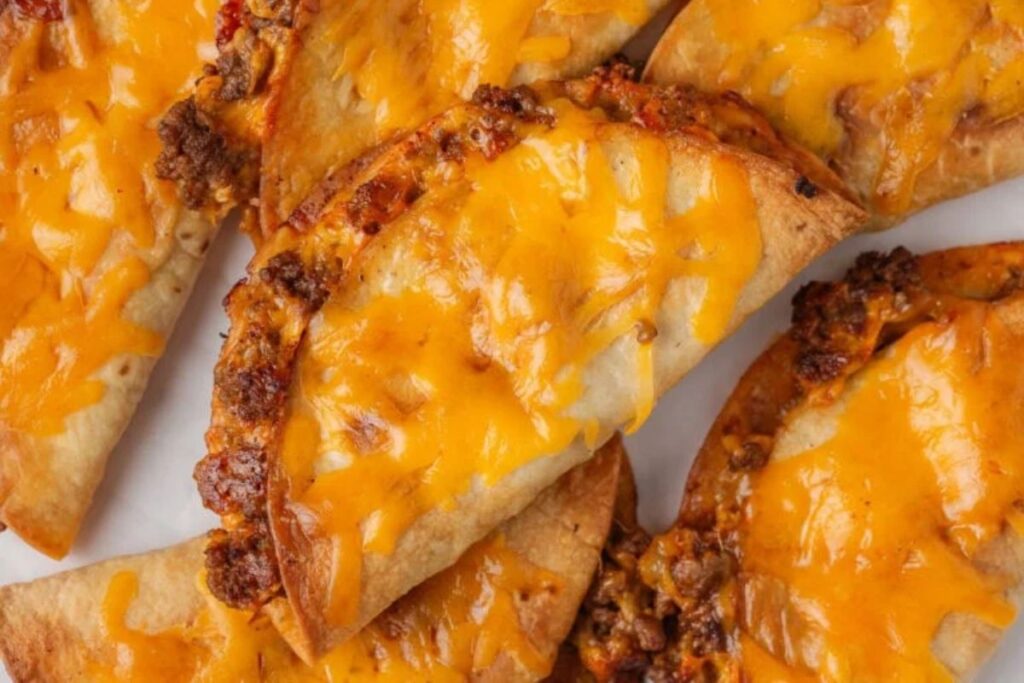 Crispy tacos with ground beef and melted cheddar cheese.