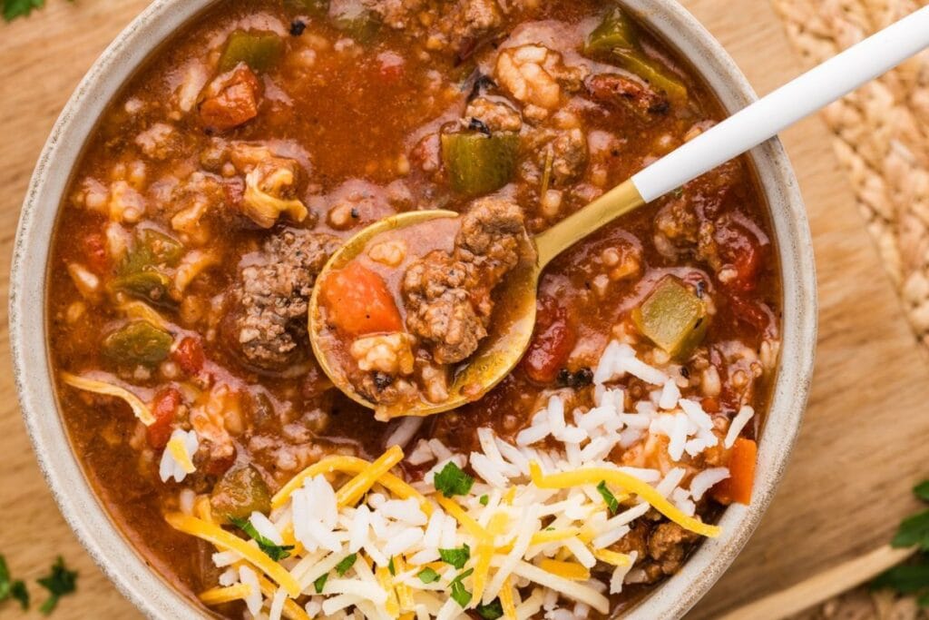 Overhead shot of stuffed pepper soup with rice, beef, and vegetables in a bowl.