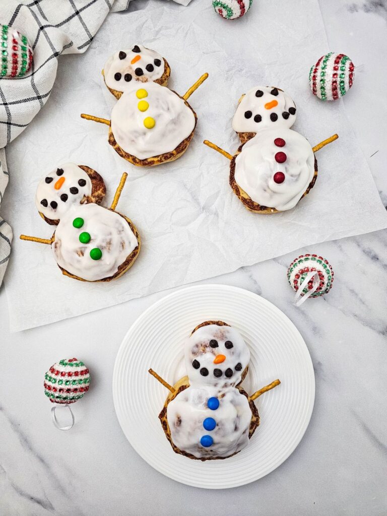 A close up shot of snowman cinnamon rolls.