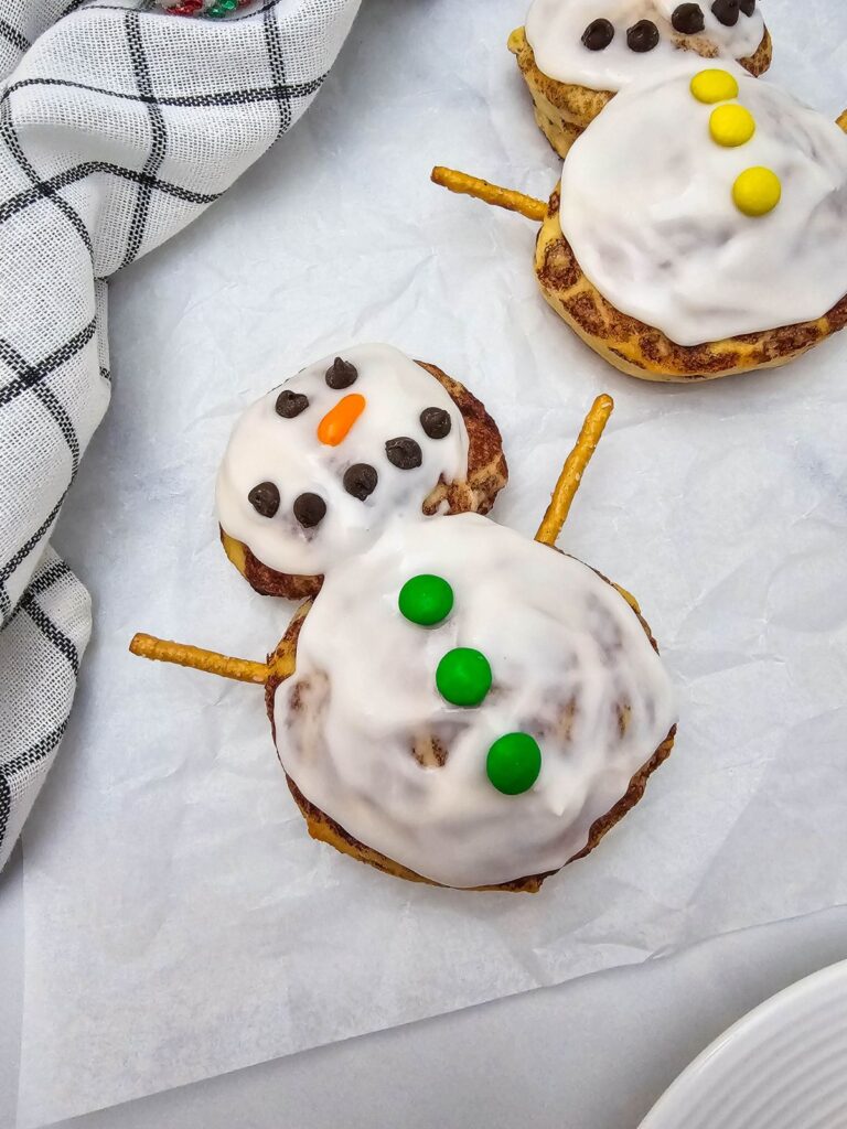 A close up shot of snowman cinnamon rolls.