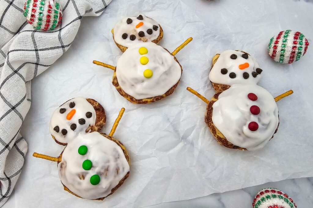 A close up shot of snowman cinnamon rolls.
