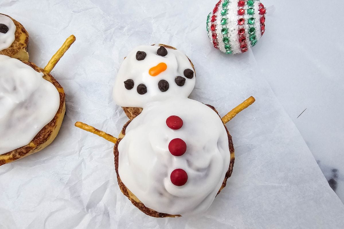 A close up shot of snowman cinnamon rolls.