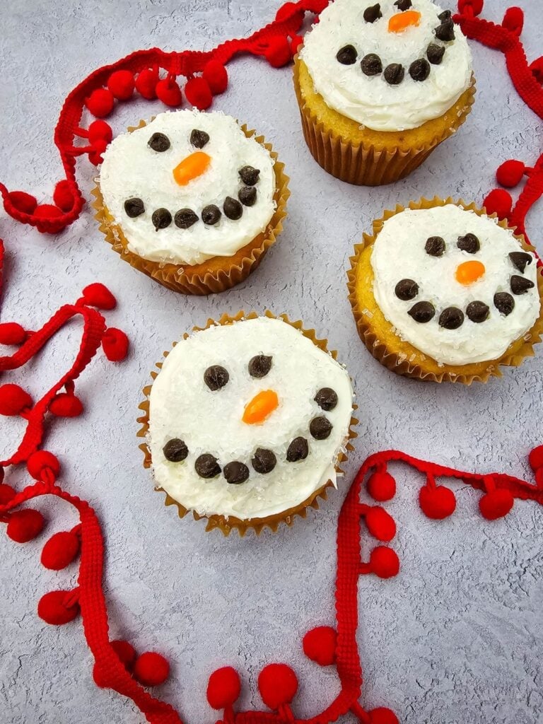 A close up shot of snowman cupcakes.