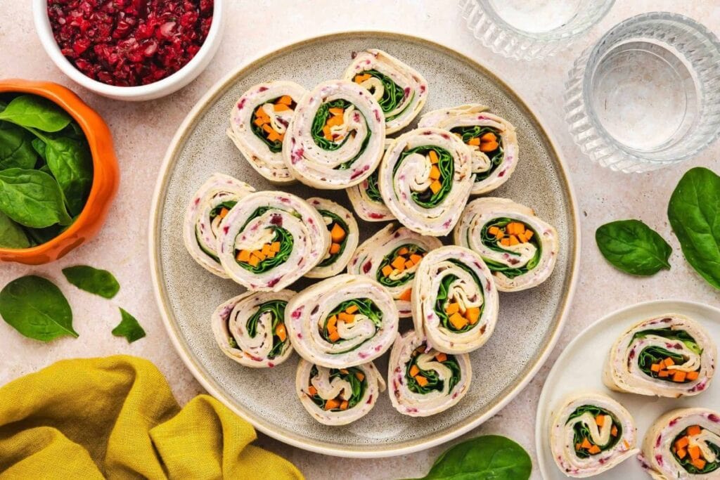 Turkey roll-ups with spinach, cranberry sauce, and sweet potato.