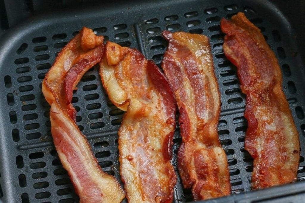 Bacon in the air fryer basket.