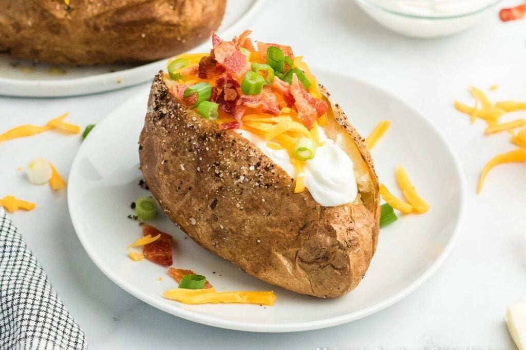Air fryer baked potatoes on a plate.