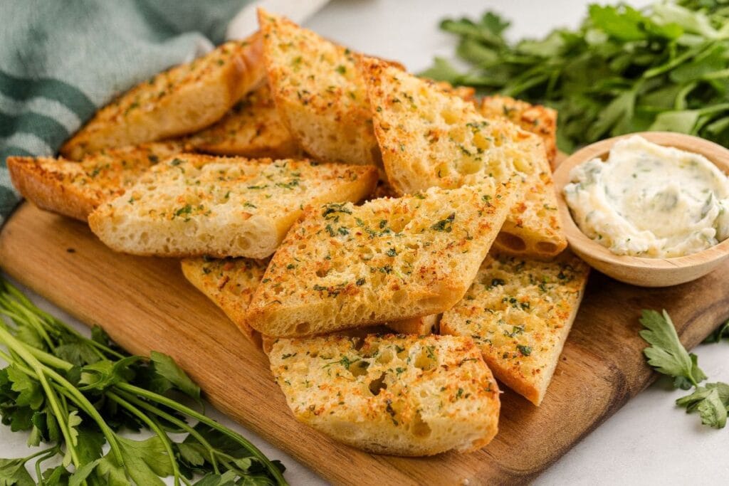 Air fryer garlic bread on a wooden board.