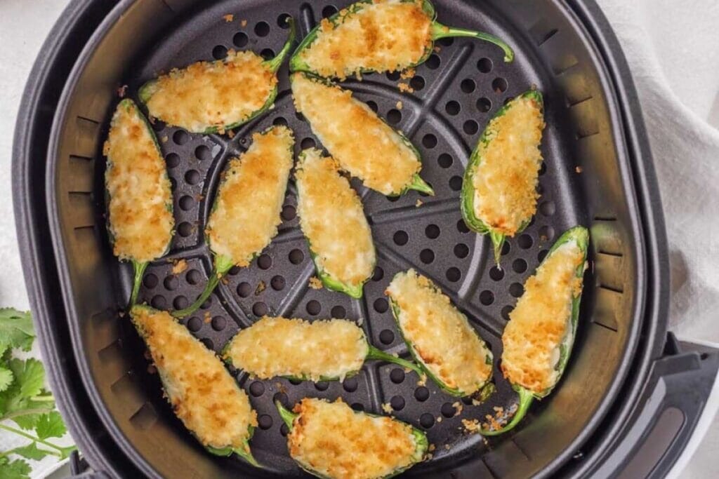 Jalapeño poppers in the air fryer basket.
