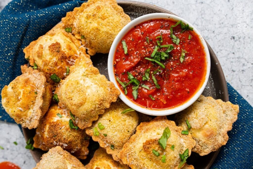 Air fryer ravioli on a plate served with ketchup.