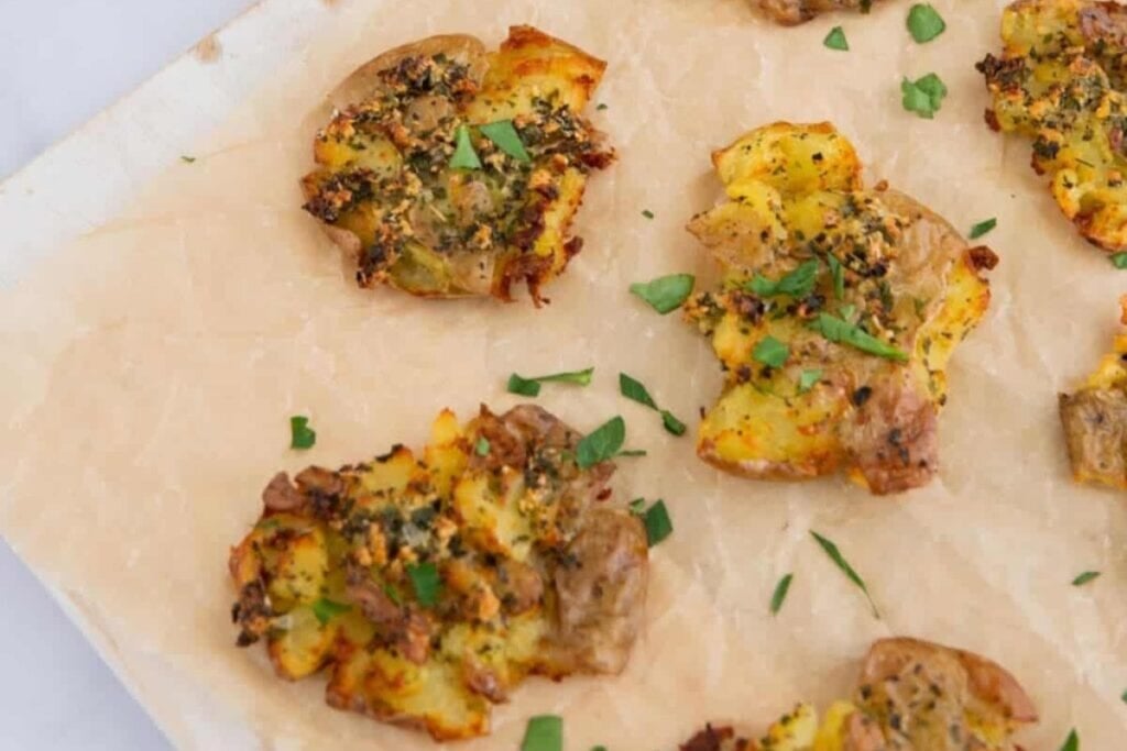 Air fryer smashed potatoes on parchment paper.