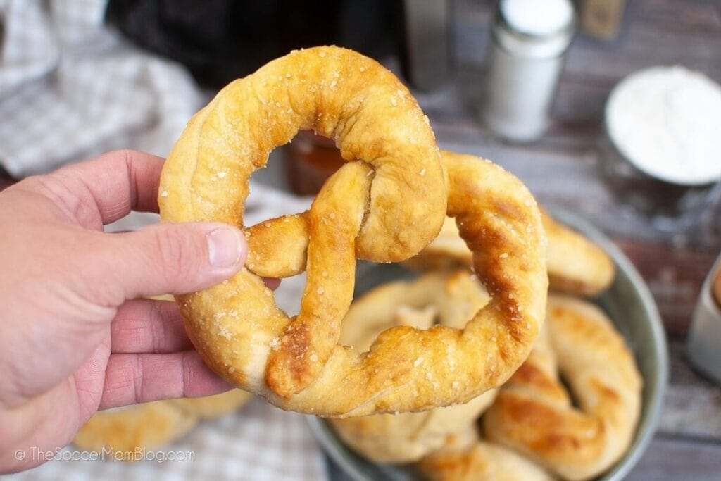 Hand holding an air fryer soft pretzel.