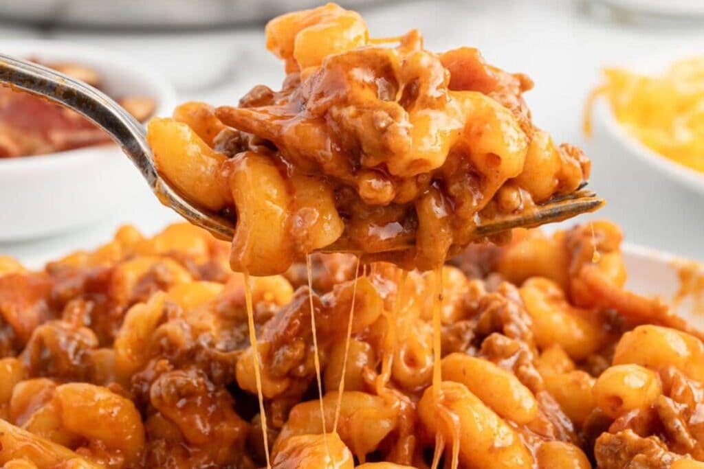 Close-up of bacon cheeseburger pasta on a fork.