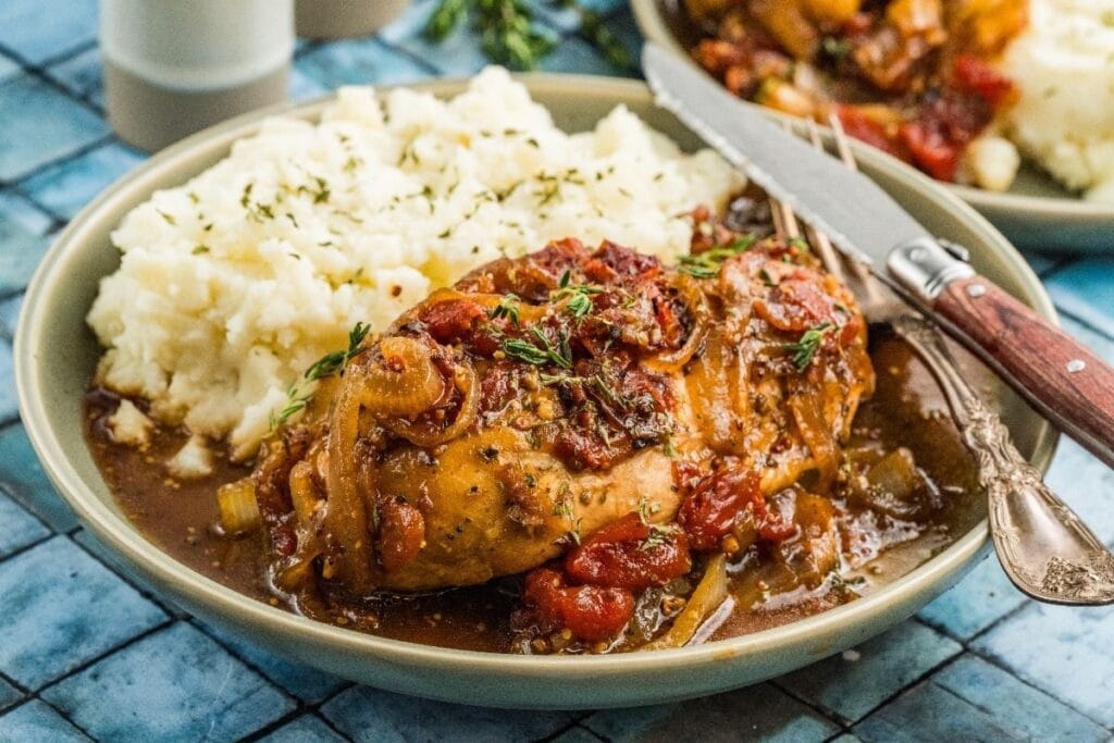 Balsamic chicken served with mashed potatoes on a plate.