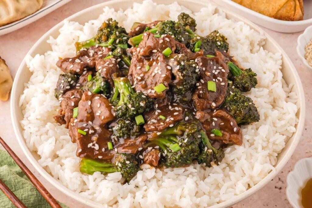 Beef and broccoli stir-fry served with rice in a bowl.