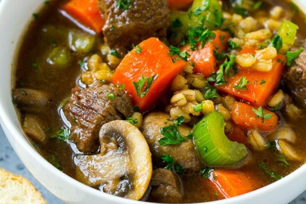 Beef barley soup in a bowl.