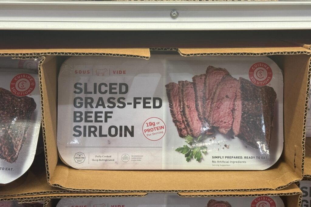 Fully cooked beef sirloin on a store shelf display.
