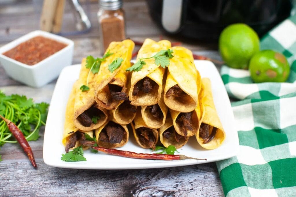 Beef taquitos on a plate.