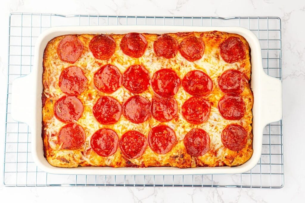 Bubble up pizza bake with melted cheese and pepperoni in a baking dish.