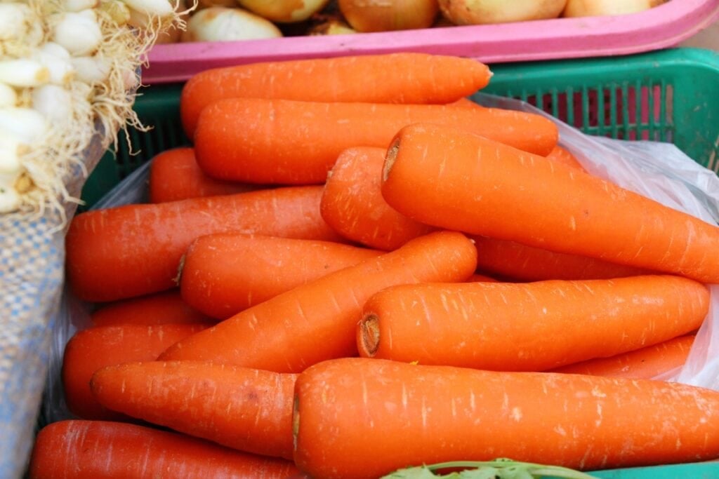 Basket of carrots on display in a supermarket.