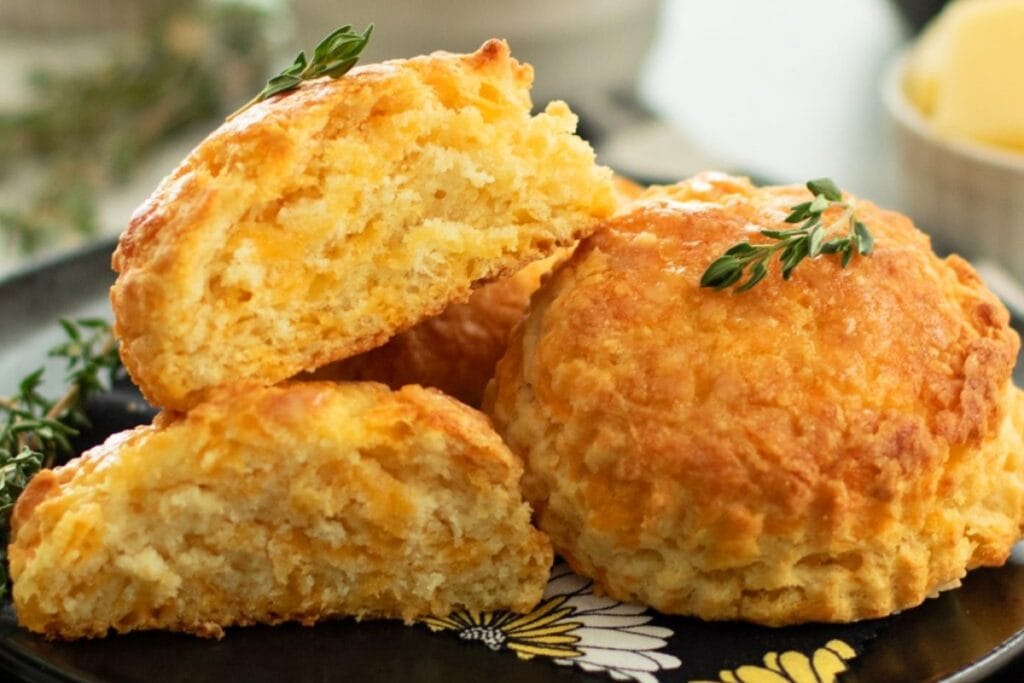 Close up of cheese biscuits on a plate.