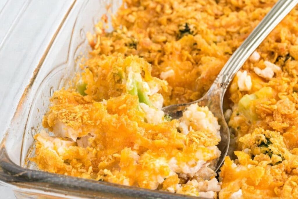 Chicken and rice casserole with broccoli and melted cheese in a baking dish.