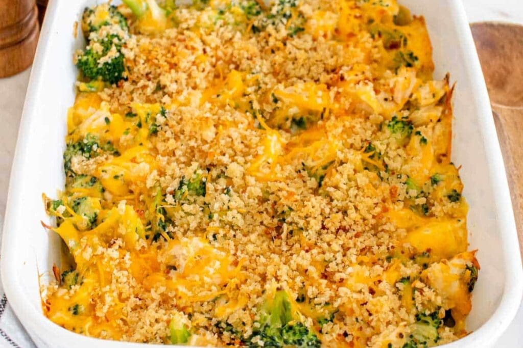 Chicken divan casserole with broccoli and cheese in a baking dish.
