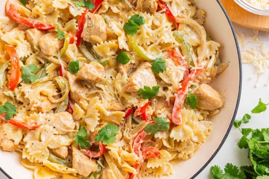 Creamy chicken fajita pasta with bell peppers in a bowl.