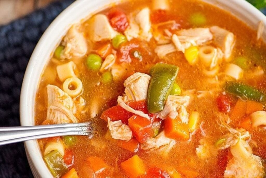 Chicken vegetable soup in a bowl.