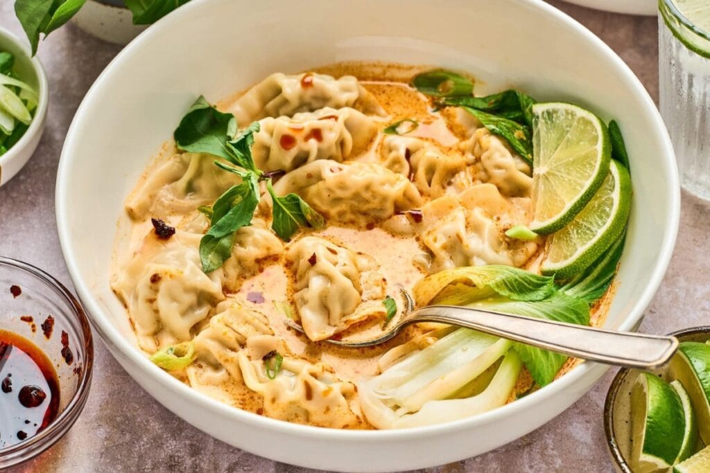 Coconut curry soup with wontons in a bowl.