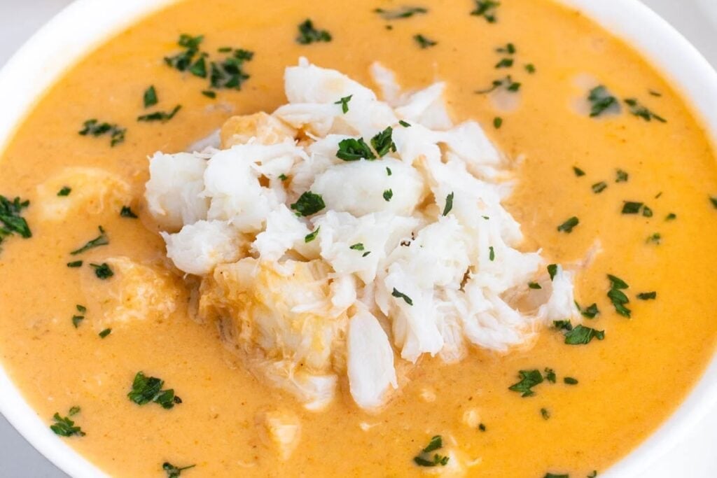 Crab bisque in a white bowl.