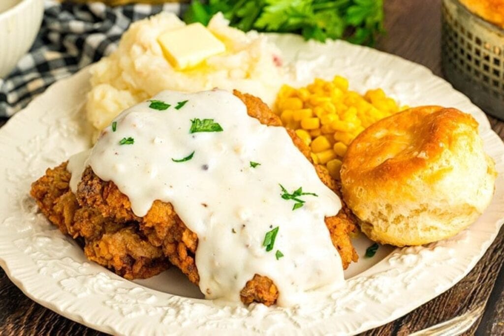 Cracker barrel country fried steak on a plate with gravy.
