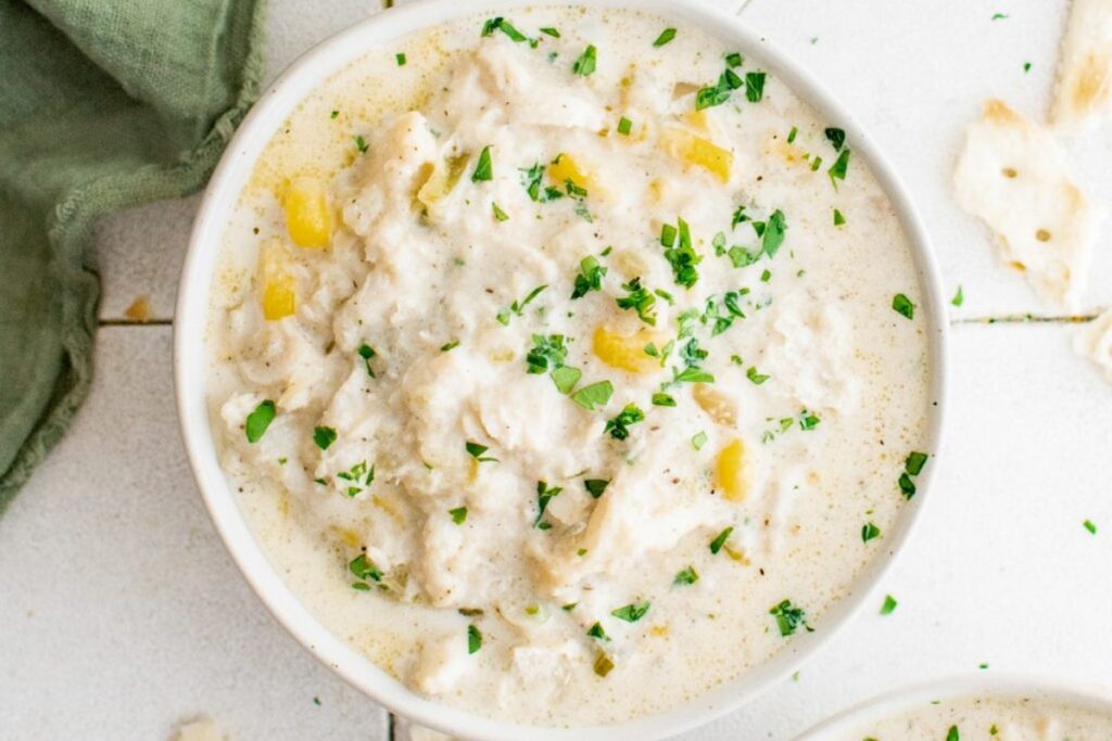 Creamy crab soup in a white bowl.