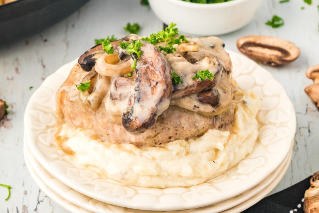 Cream of mushroom pork chops on a plate.