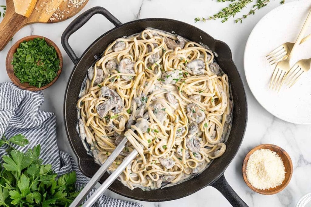 Creamy mushroom pasta in a skillet.
