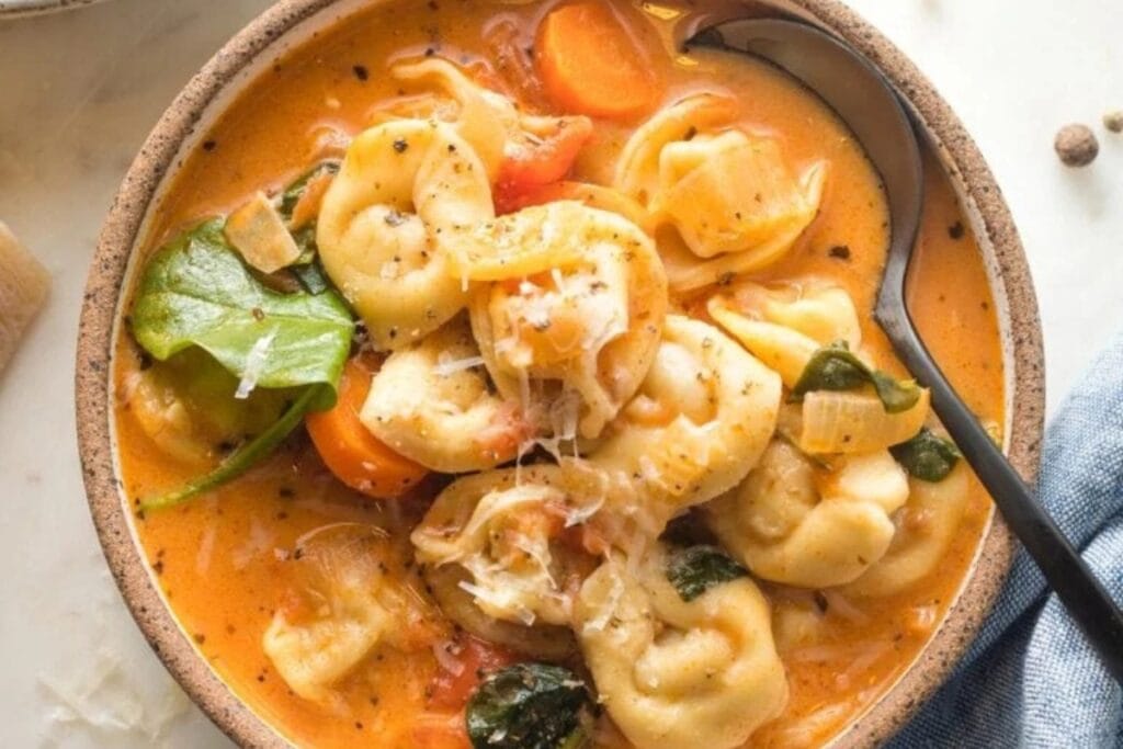 Creamy tomato tortellini soup in a bowl.