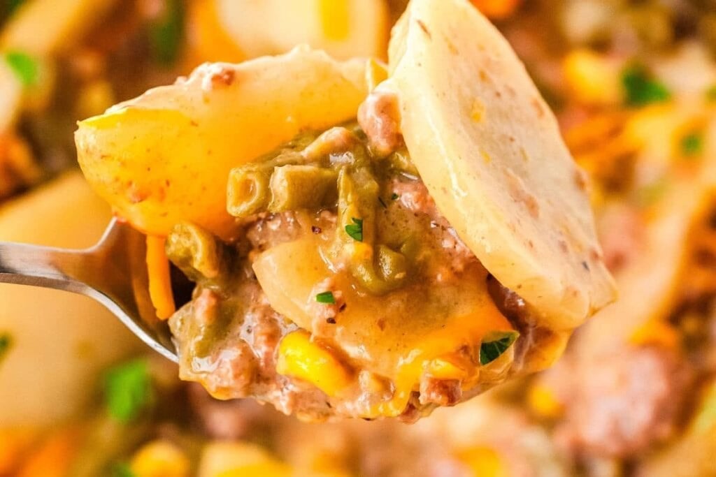 Close-up of crockpot cowboy casserole on a fork.