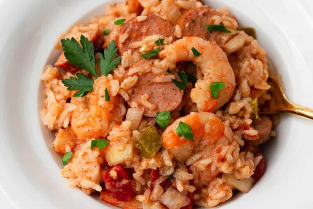 Crockpot jambalaya with rice, sausage, shrimp, and vegetables in a bowl.