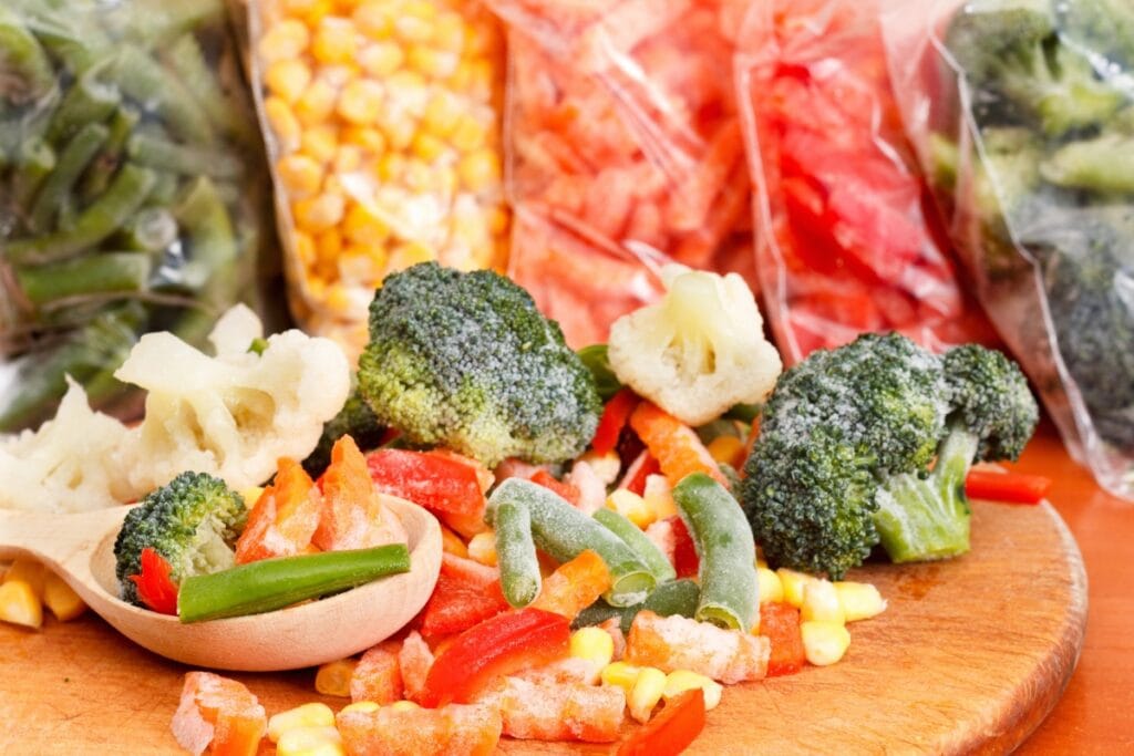Frozen vegetables on a wooden board.