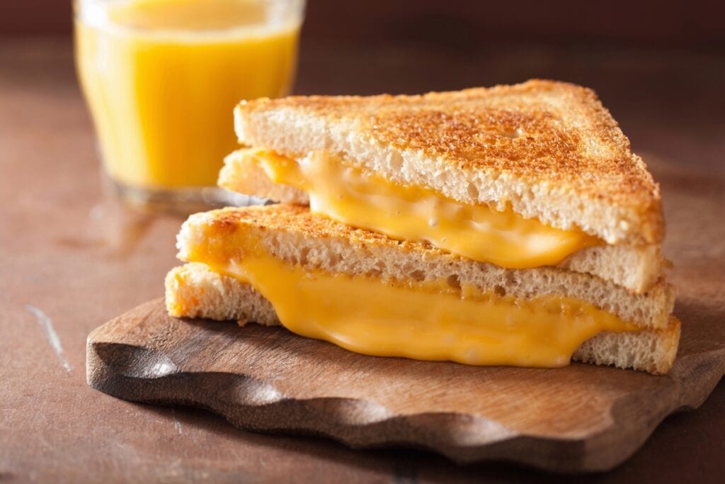 Grilled cheese sandwich on a wooden board..