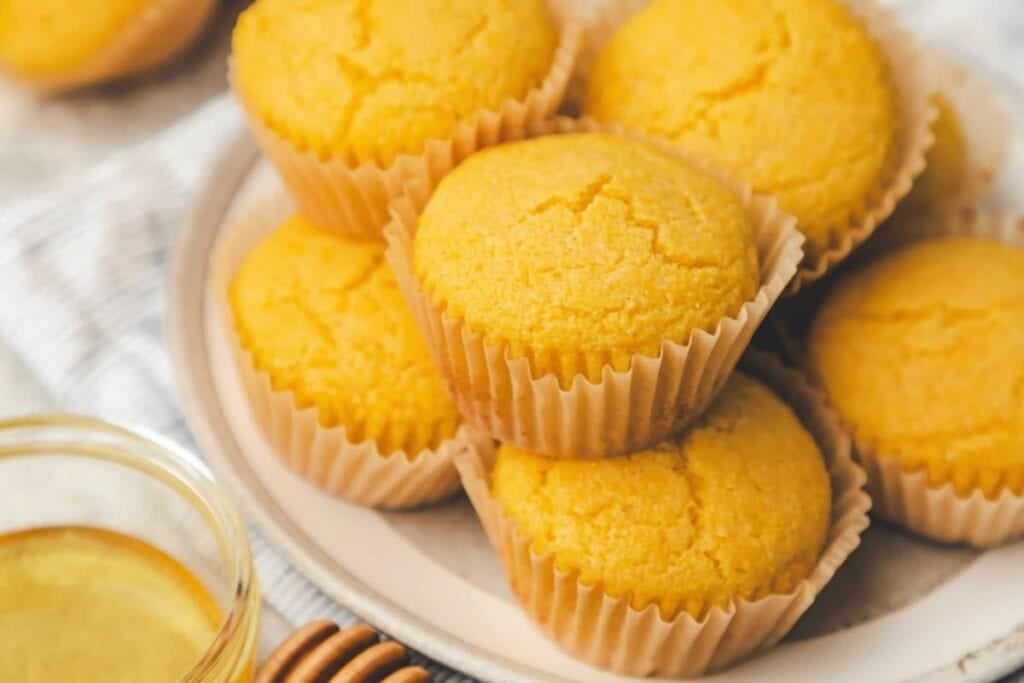 Honey cornbread muffins on a plate.