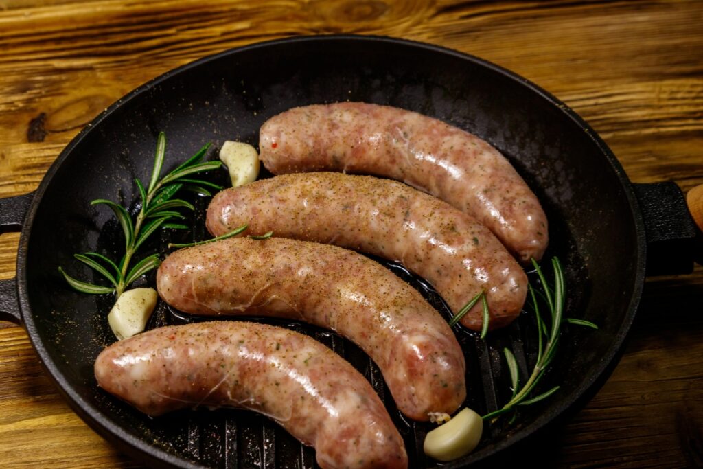 Italian sausages in a skillet.