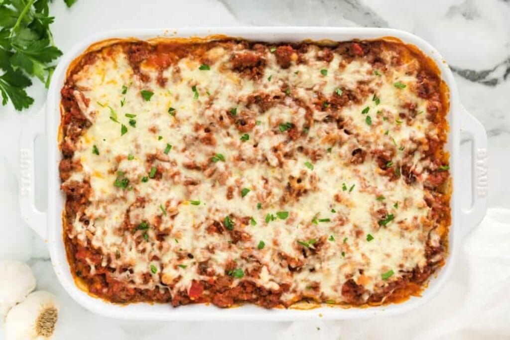 Top view of Million Dollar Spaghetti Casserole with melted cheese and parsley.