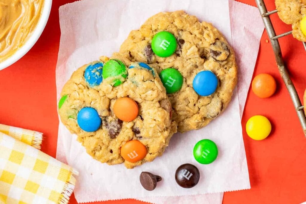 M&M peanut butter monster cookies on parchment paper.