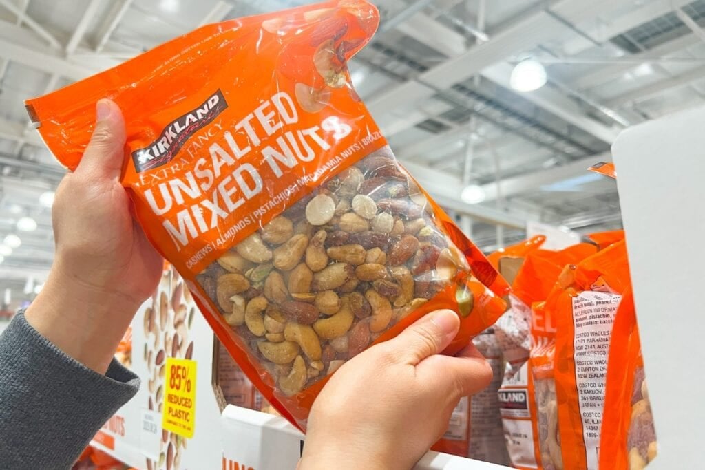 Holding a pack of mixed nuts from store shelves.