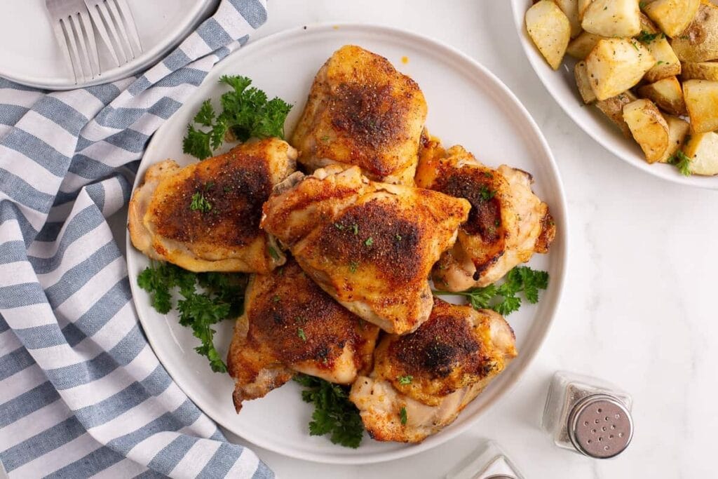 “Oven-baked chicken thighs served on a plate.